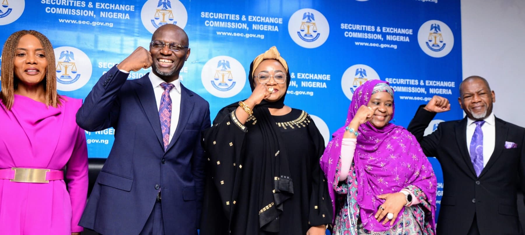 NASDeP representatives celebrating in front of a Securities and Exchange Commission, Nigeria backdrop