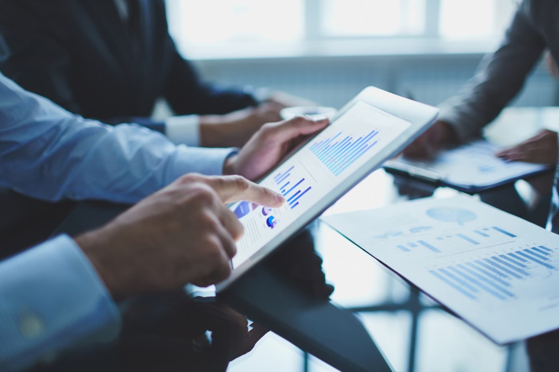 Business people reviewing charts on a tablet